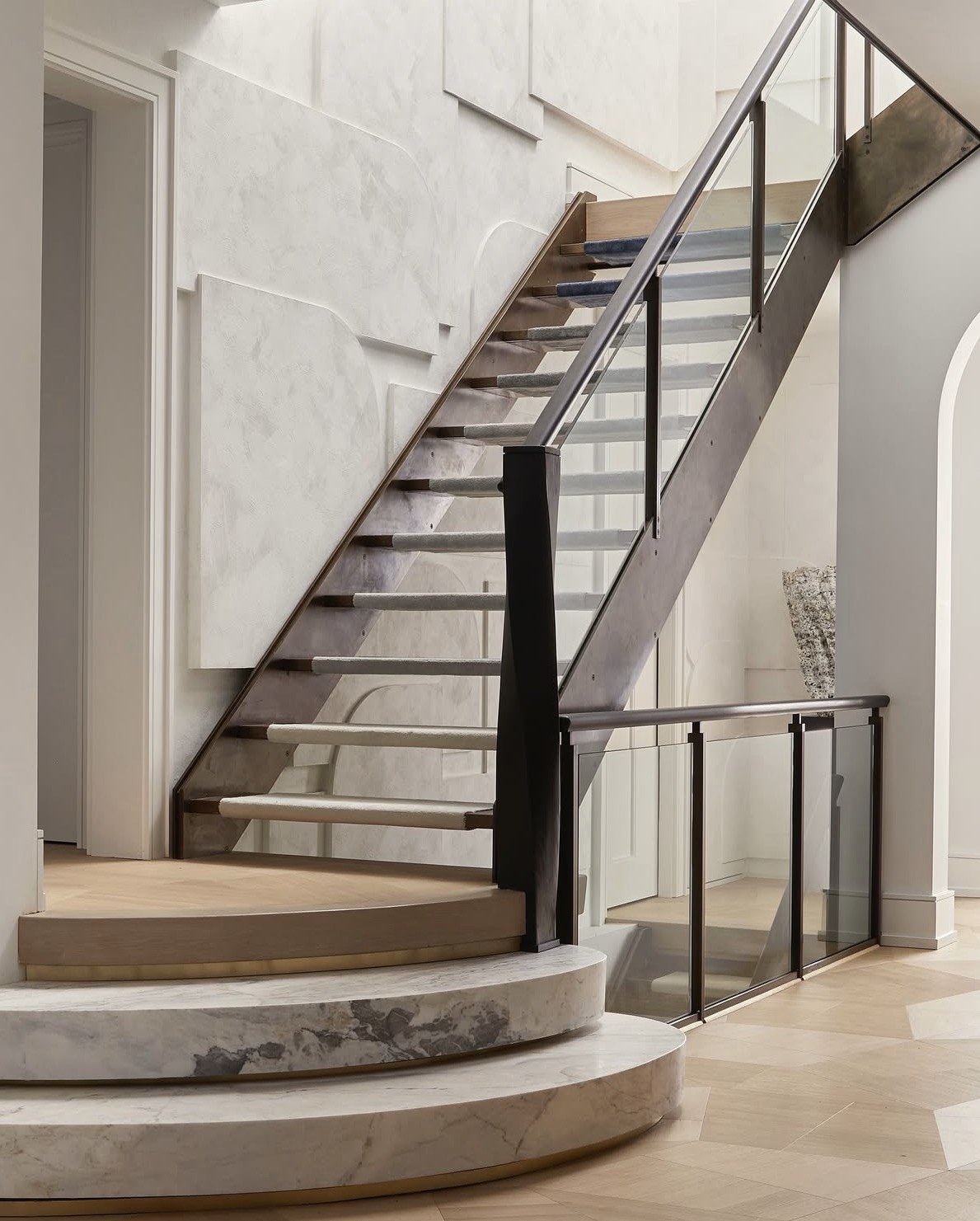Sculptural staircase with plaster wall detail by Anchored Interiors