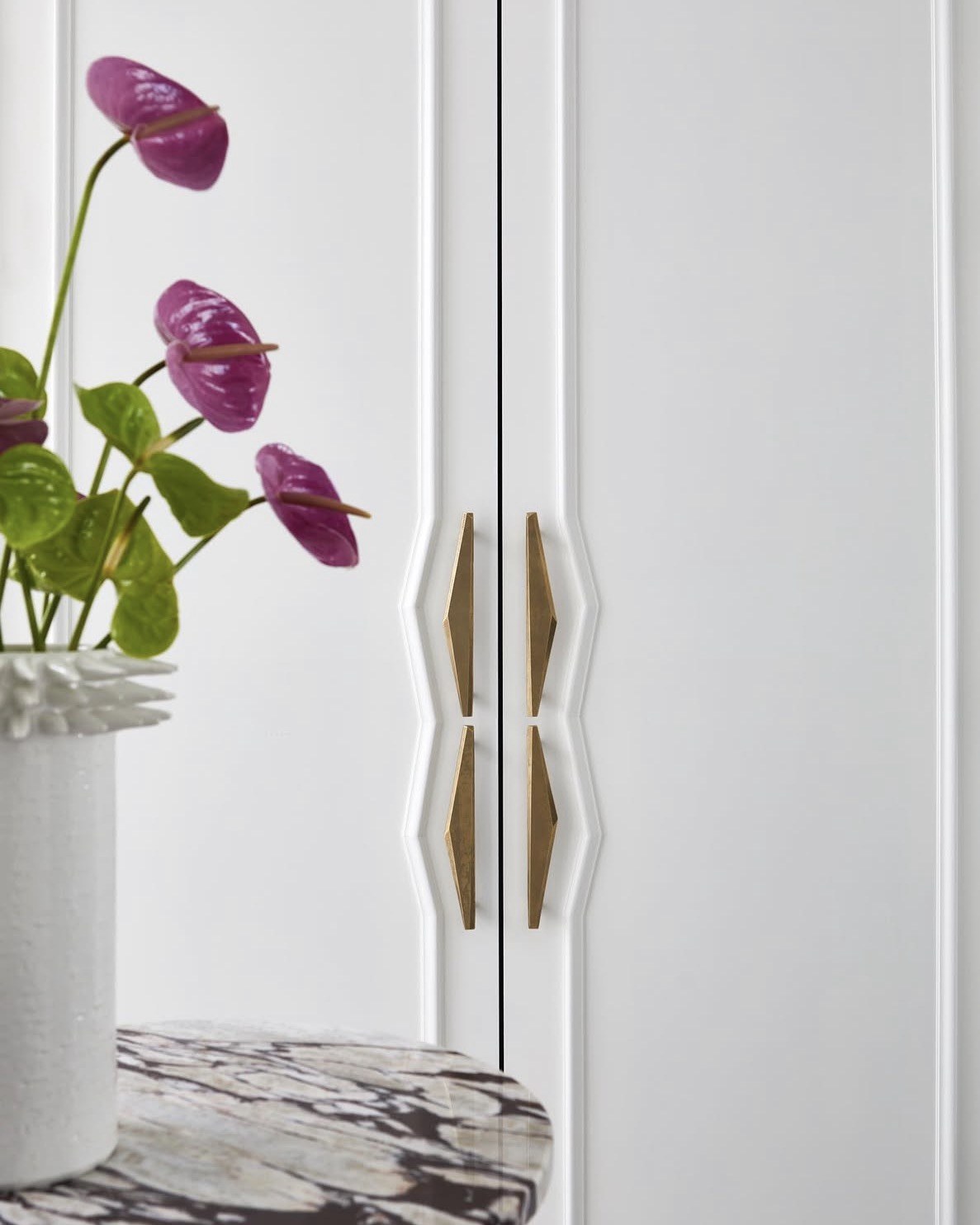 Custom brass diamond hardware pulls on millwork doors